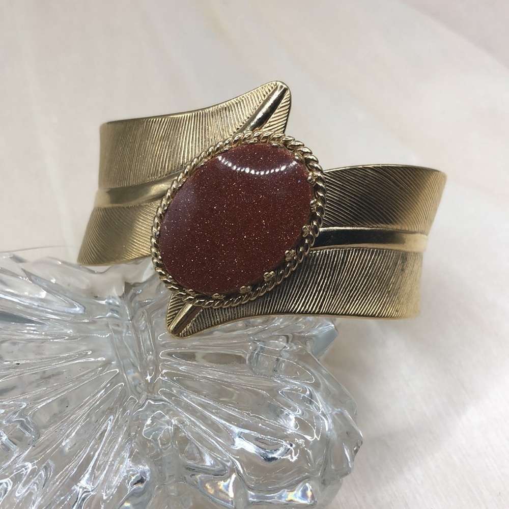 Vintage costume hinge clamper bracelet with goldstone center-modernist.